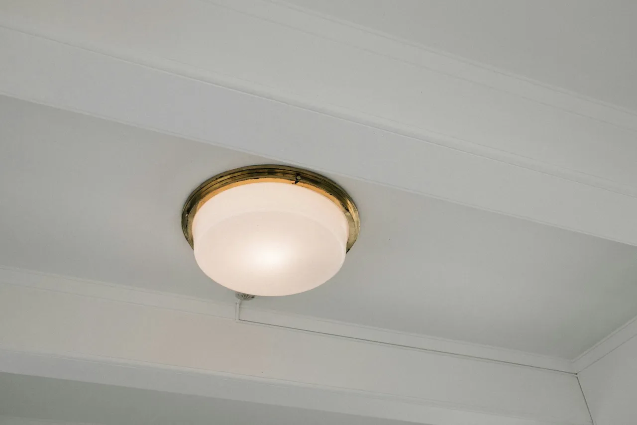 A pendant light fixture hanging above a dining area