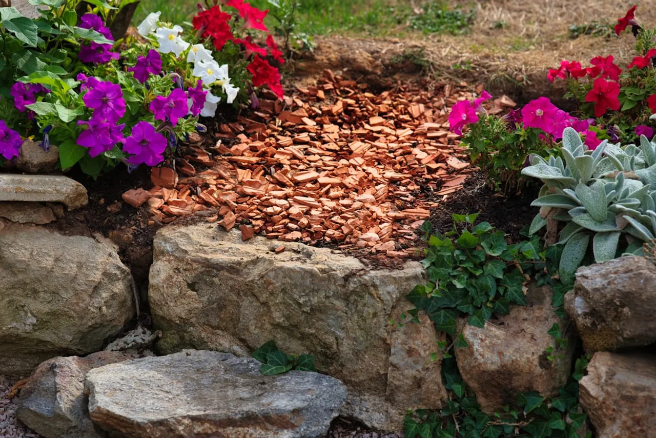 A planted bed edged with stone where trim around beds and walks can be reviewed