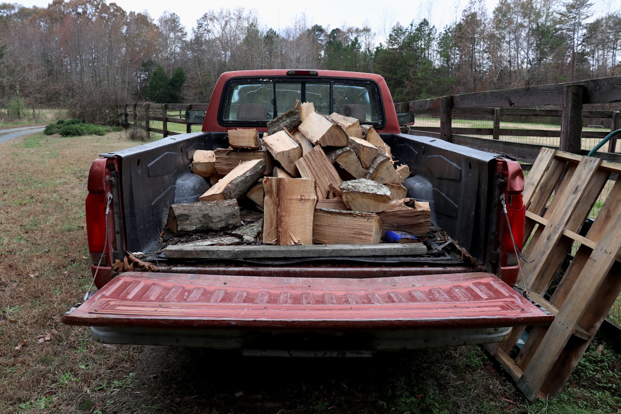 A pickup truck bed loaded with cut wood ready to be hauled away