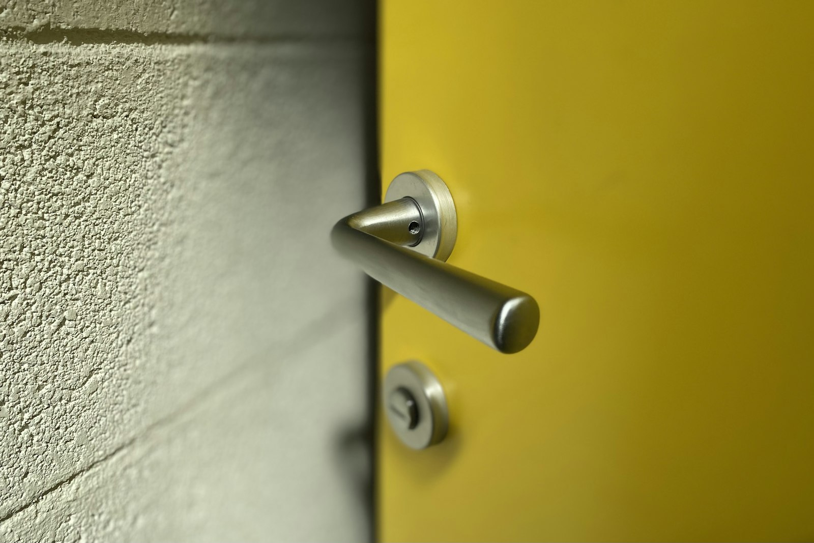 A lever handle and deadbolt on a painted interior door